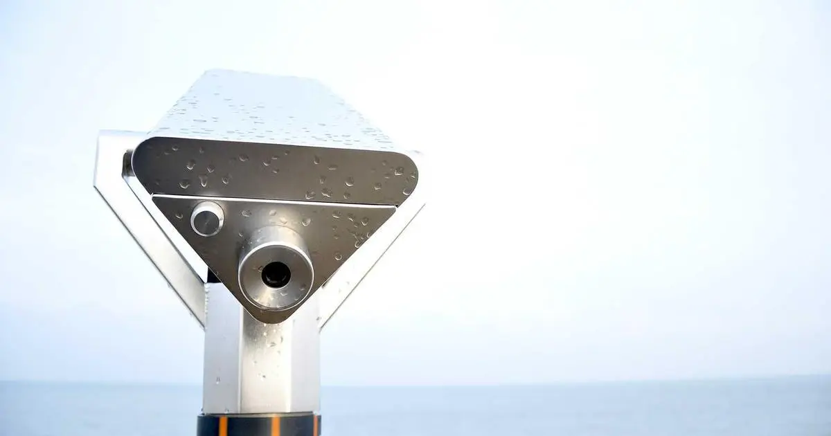a professional photographer setting up for a US visa photo session
